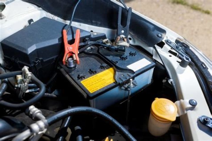 Can you clean a car battery without disconnecting the cables?