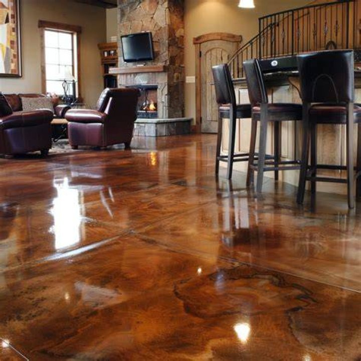 Can you tile over a stained concrete floor?