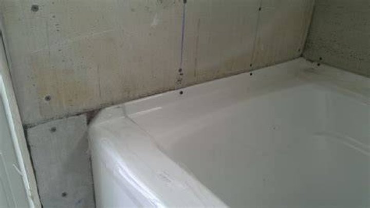 Does cement board go over lip of shower pan?