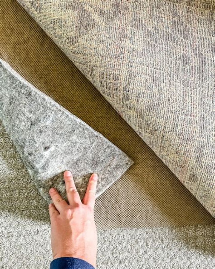 How do you keep a rug from curling on carpet?