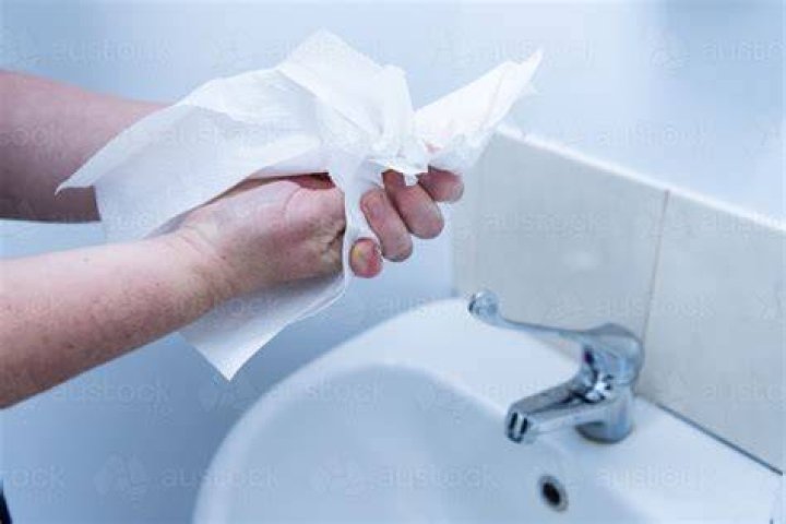 Should you use cloth or paper towels to clean up blood?