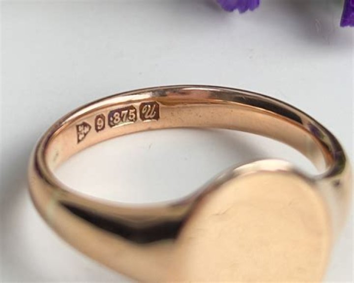 What does GE stand for on gold ring?