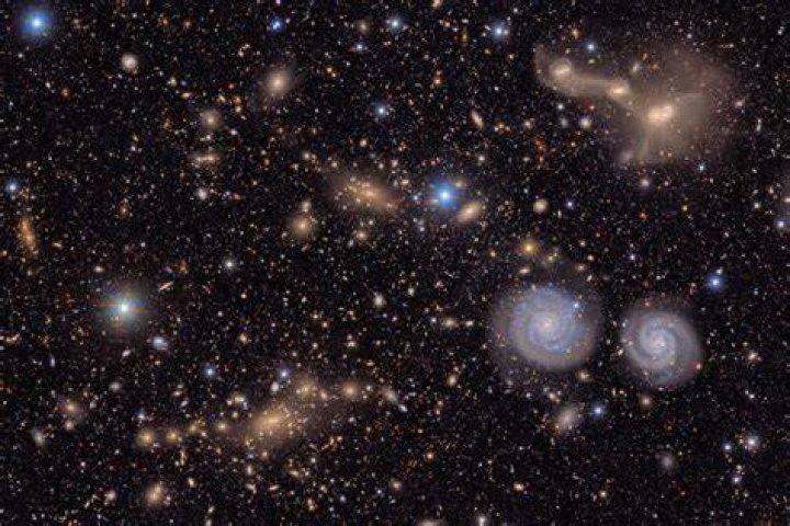 When viewed from Earth the light from very distant galaxies shows a red shift this is evidence that these distant galaxies are?