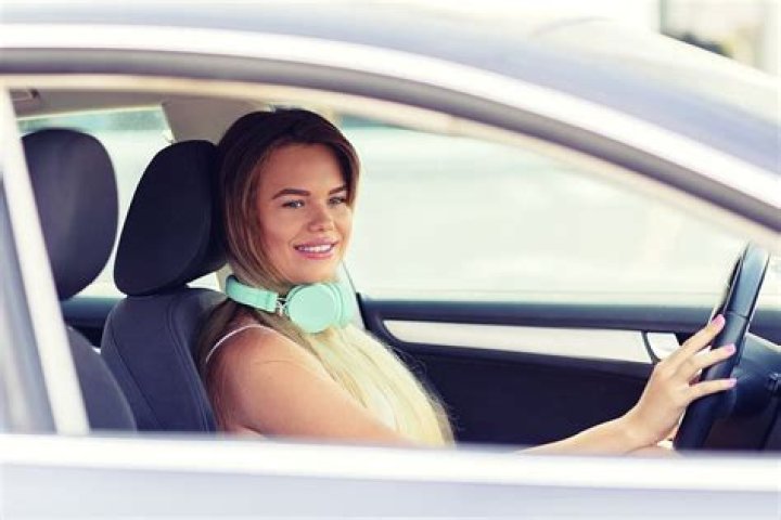 Who may legally drive with a headset covering both ears?